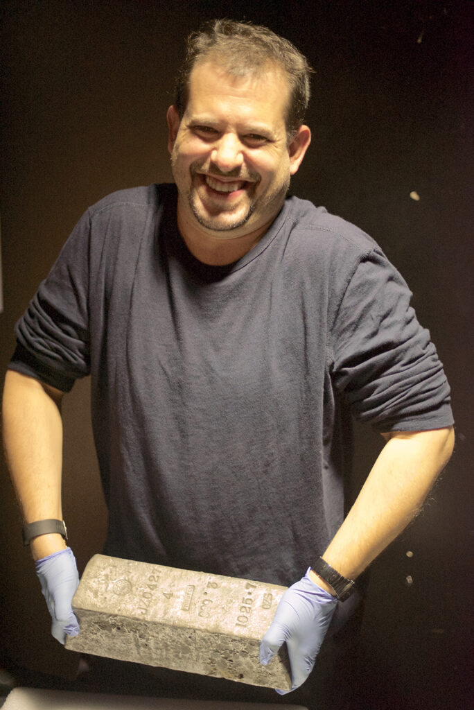 Aaron Sylvan holding silver ingot at TEDxFultonStreet 2015